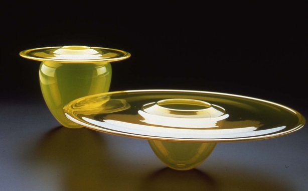 Two yellow planet-like blown glass objects