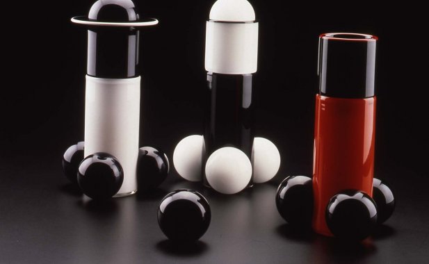 Red black and white cylindrical glass objects with attached balls