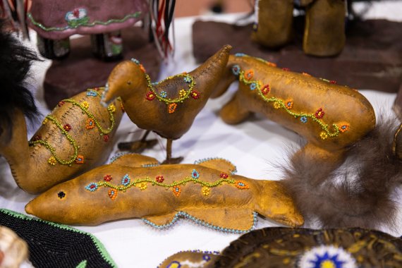bird and fish dolls made from buckskin and adorned with beads