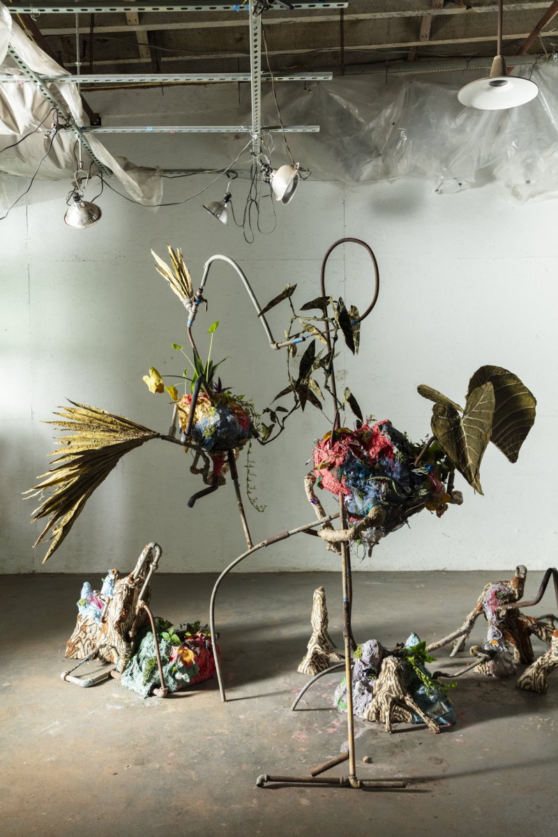 The artist’s sculpture Bottomland Chimera, 2023, is made from materials including metal, lime, and recycled paint; paper made from sugarcane and plastic waste; ink derived from brick, goldenrod, copper, fossil fuel pollution, oak gall, and more; and soil and living plants; 90 x 115 x 85 in. Photo by Cedric Angeles.