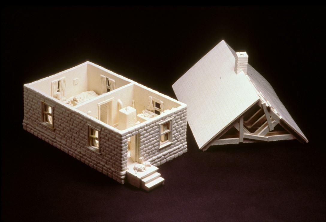 Ceramic house with the top removed exposing the interior layout.