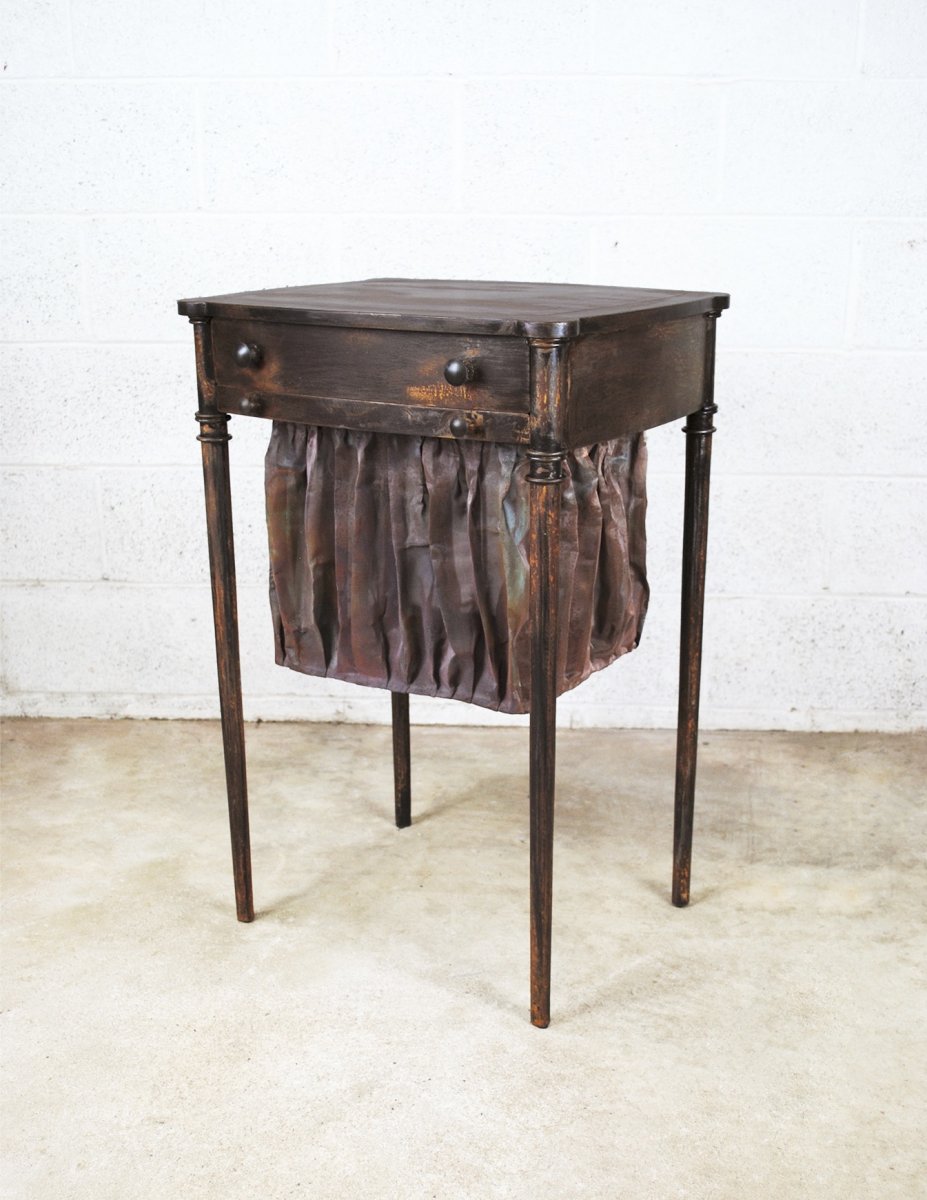 Sew What?, 2023, painted and rusted steel, patinated copper mesh, 30 x 16 x 14 in., references antique sewing tables that are typically made of wood and fabric. Photo courtesy of the artist.