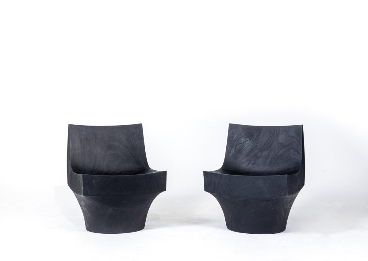 Pair of black chairs carved from solid wood