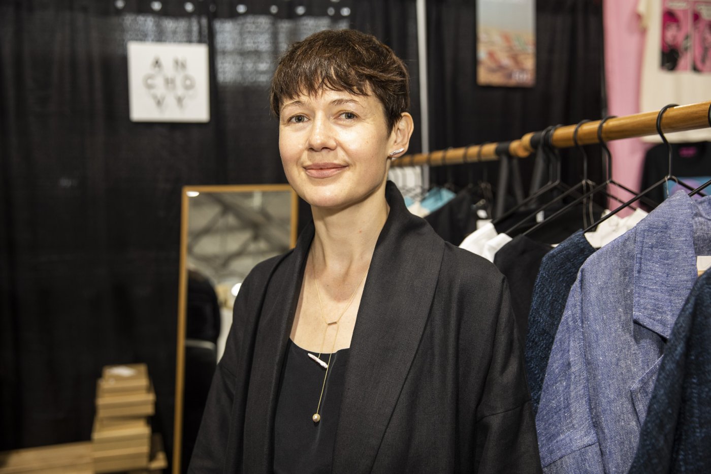 Artist Giedre Kose displays a necklace in her booth.