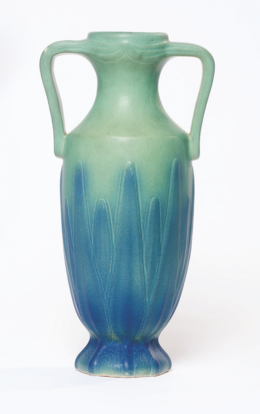 Tall vase with double handles in shades of green and blue.