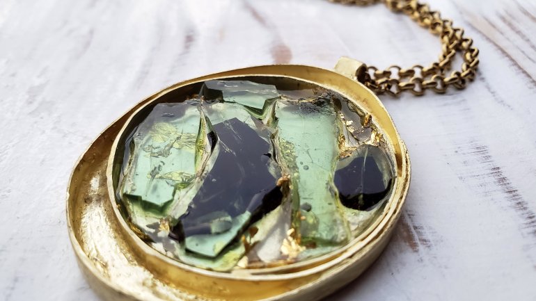 handmade gold necklace inlaid with fragments of a shattered car window