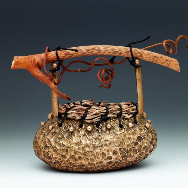 Small basket (1.5"x2"x1") made of bronze, coined palm fruit stalk, grapevine and silk.