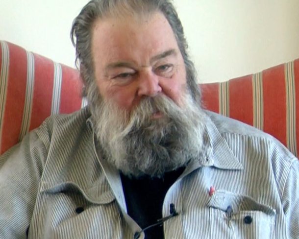 screenshot of garry knox bennett seated in red striped chair