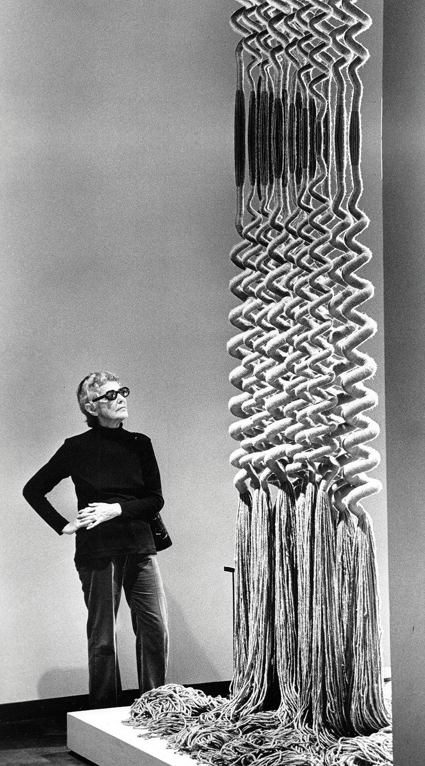 Fiber artist Claire Zeisler with her sculpture Red Forest I, which was included in the 1972 Museum of Contemporary Crafts exhibition Sculpture in Fiber.