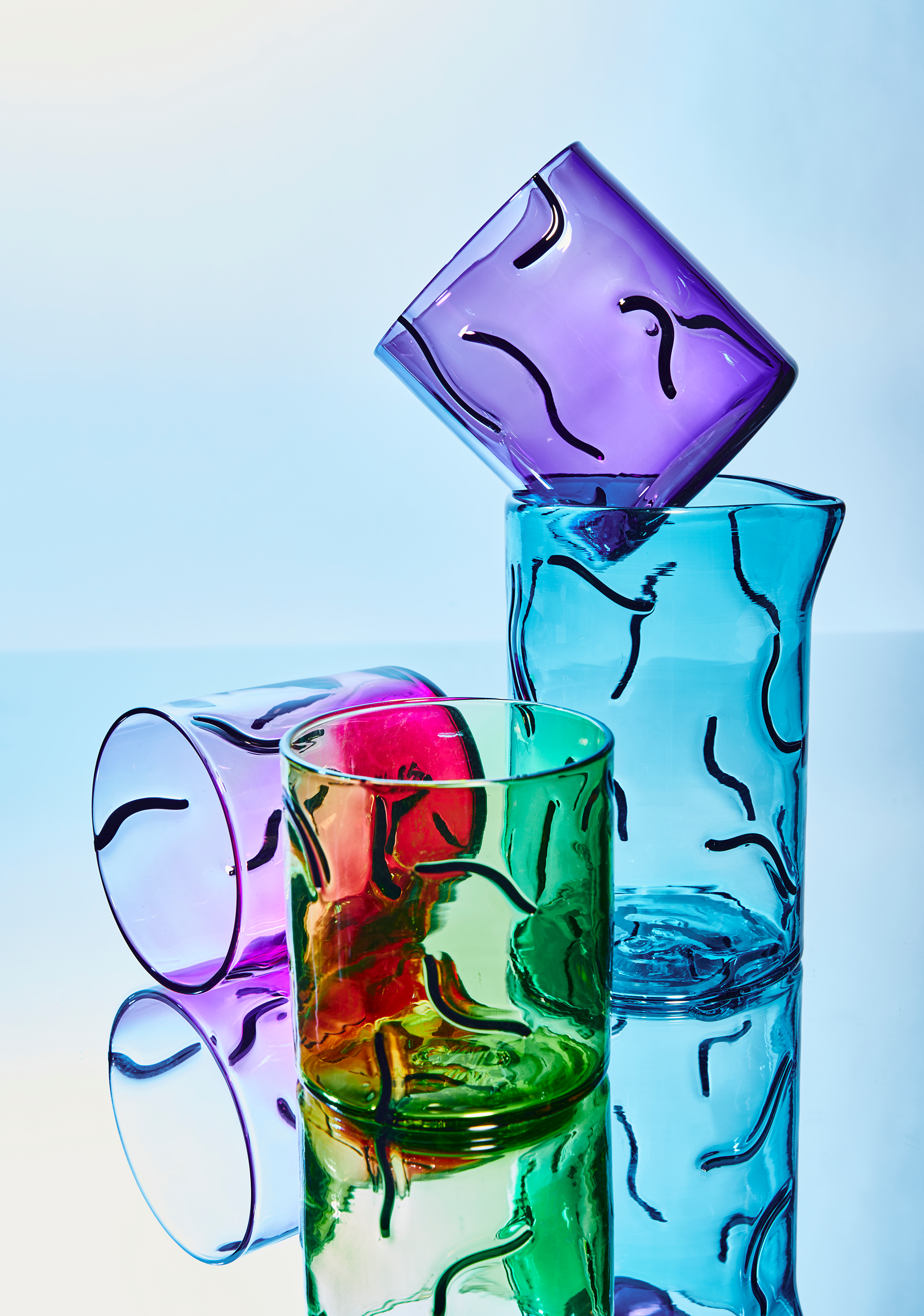 The squiggly patterns on glasses and vases in Mitchell’s Enjoué series recall transparent electronics like Game Boys and iMacs from the 1990s. Photo by Julie Dickinson.