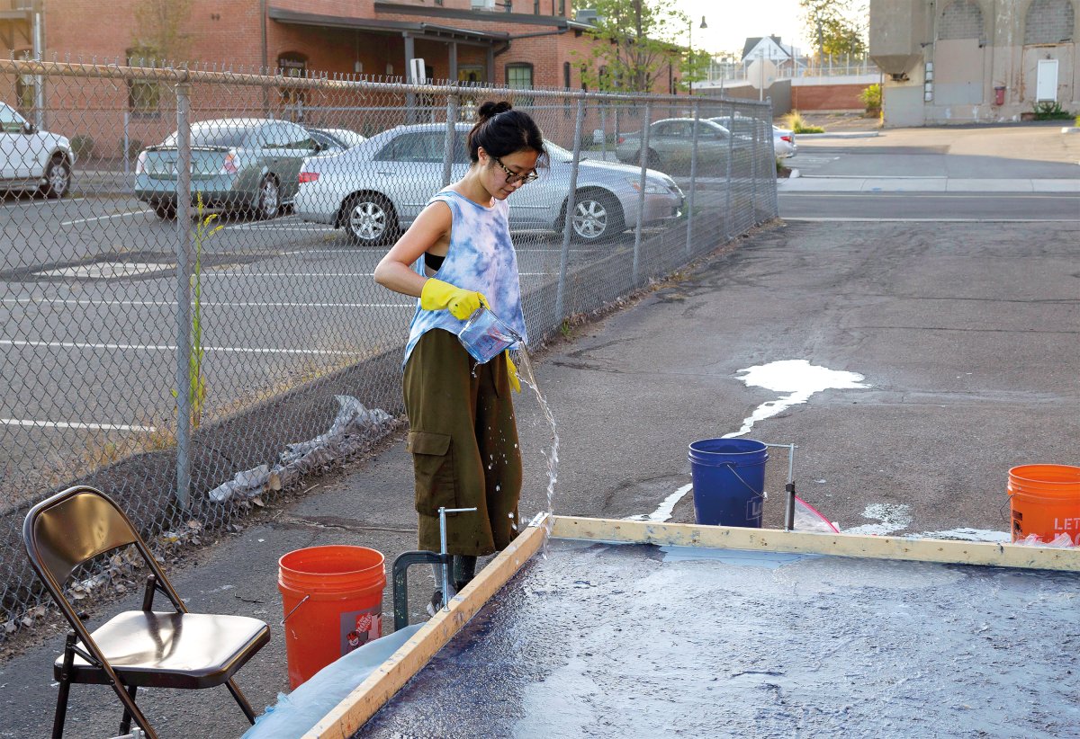 Hong works on an in-process environmental pour in Hartford, Connecticut, in 2018. Photo by Justin O’Brien, courtesy of the artist.