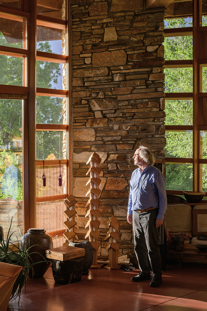   Whiting stands in front of “some of mason Kent Hale’s best work” near the prow of Teater’s Knoll. Whiting designed the “pagoda lanterns” next to him in 1985; they were built in 2018 by woodworker Paul Bates, who was also part of the 1982–83 restoration.