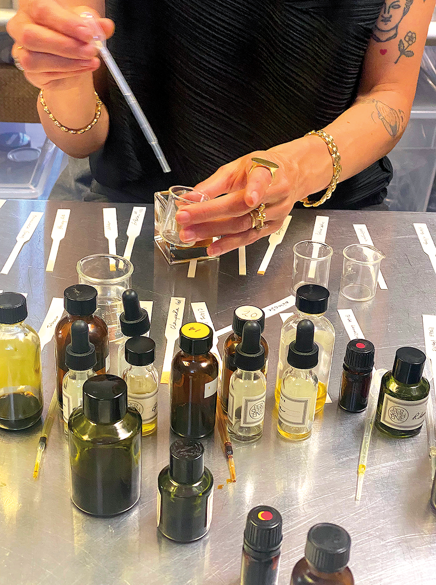 Here, she measures essential oils and absolutes to create her personal perfume.