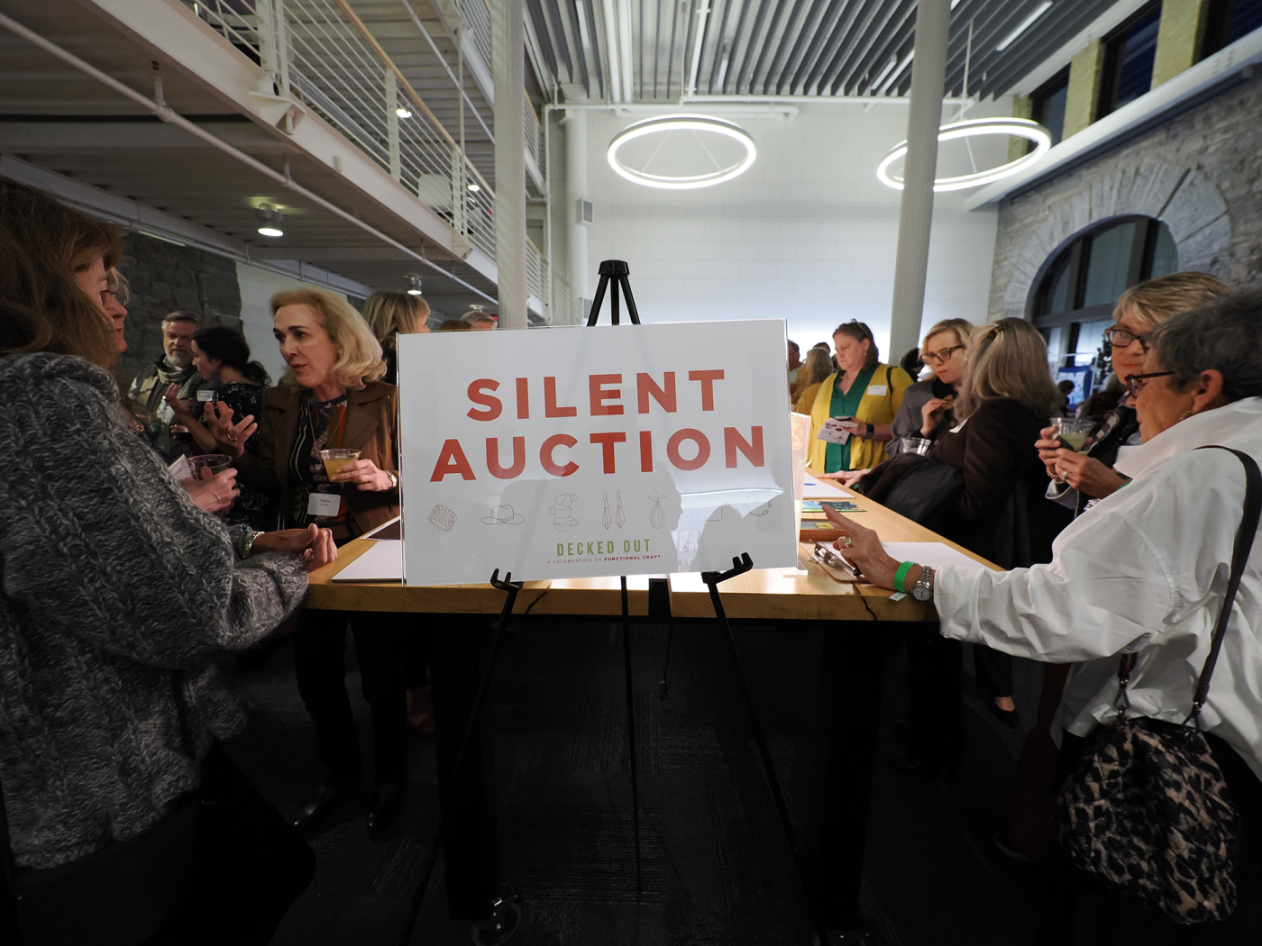 people walking around a silent auction