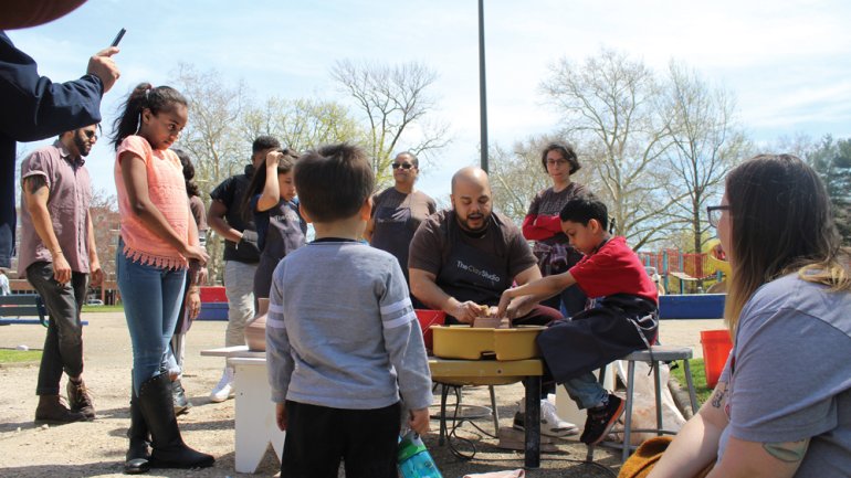 Roberto Lugo helps kids with pottery