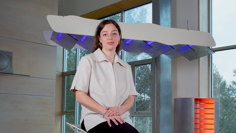 Kate Greenberg with her lighting fixtures Radiator and Felled Sky. Photo by Sahra Jajarmikhayat.