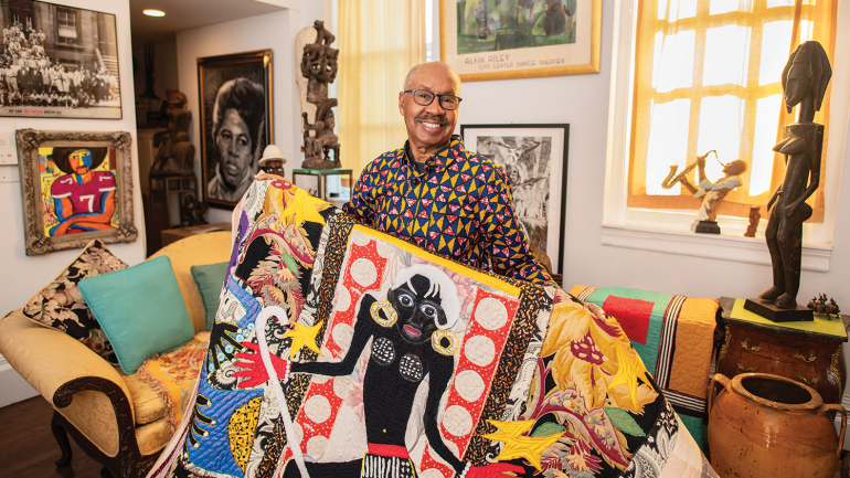 Michael A. Cummings holds his quilt Henri Matisse in Harlem’s Cotton Club, 2018, 78 x 64 in. Photo by Tom Pich. 