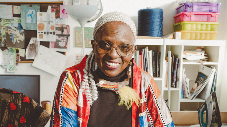 Diana N’Diaye with Ba and Her Daughters, a quilt she made to honor her great grandmother. Photo by Reginald Cunningham.