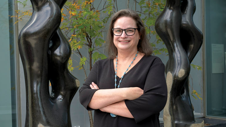 Cindi Strauss acquired the work behind her—Byung Hoon Choi’s basalt sculpture Scholar’s Way, designed in 2017 and made 2017 to 2019—for the Museum of Fine Arts, Houston. Photo by Thomas R. DuBrock.