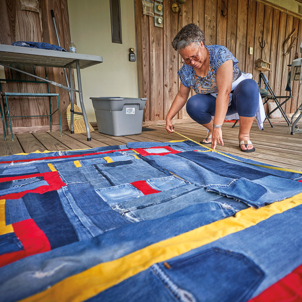 Pettway Bennett lays out a quilt.