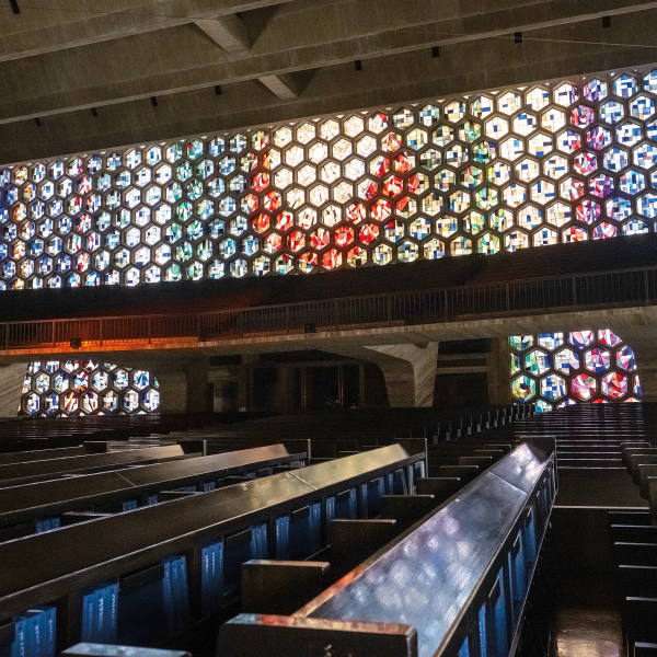 A wall of stained glass illuminates the Saint John’s Abbey and University Church.