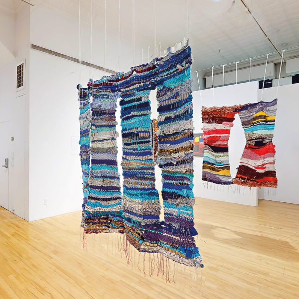 In the foreground, Mayela’s Healing Color, 2023, was made as a healing gesture to migrants who have donated materials, 48 x 45 in. Photo by apexart.