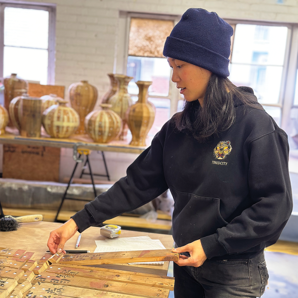 Chiu arranges crate pieces in her studio in Richmond, Virginia. Photo by Sarah Darro.