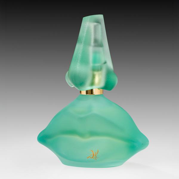 While best known for his surrealist paintings, Salvador Dalí also dreamed up this green glass bottle, complete with nose and mouth, for his 1983 Laguna perfume. It will appear in Sensorium: Stories of Glass and Fragrance at the Corning Museum of Glass. Photo courtesy of the Corning Museum of Glass.