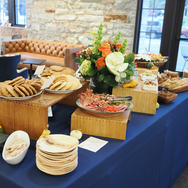 table full of catered food and flower arrangement