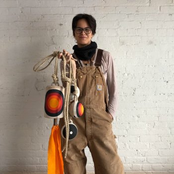 Portrait of Michele Quan holding artwork