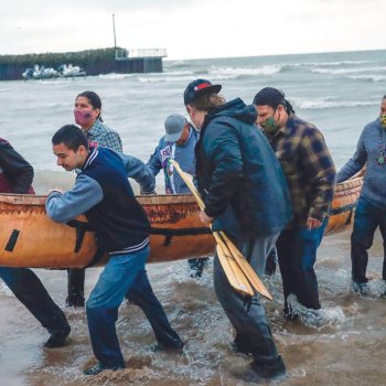 Group carrying a canoe.