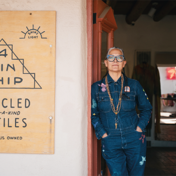 Amy Denet Deal stands at the entrance to 4KINSHIP, which she opened in Santa Fe in 2022. Photo by Wade Adakai.