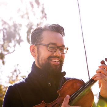 Virtuoso violinist and Street Symphony artistic director Vijay Gupta with a prized violin made by luthier Eric Benning. Photo by Kat Bawden.