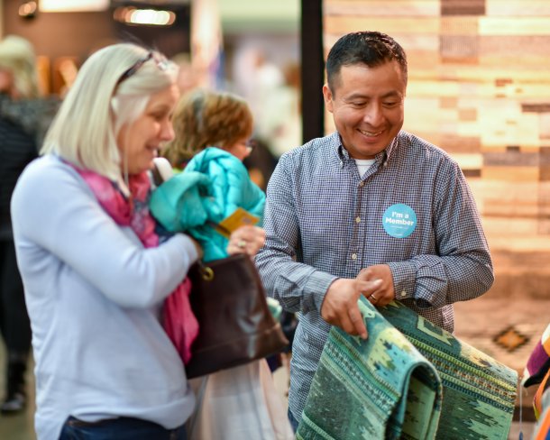 A shopper and an member-artist at an American Craft Show