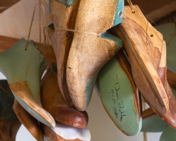 A collection of lasts—forms used to make shoes—hangs in Amara Hark-Weber’s studio in Saint Paul. Photo by Dina Kantor.