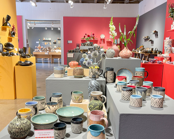 Part of a Northern Clay Center fundraiser, this installation features the work of Donna DeSoto in the foreground. Photo courtesy of Northern Clay Center.