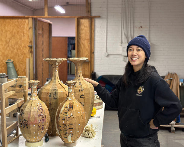 Vivian Chiu with vessels from her Passages (those that carried us) series. Photo courtesy of the artist.