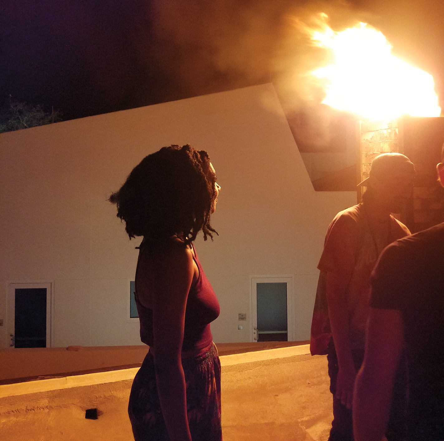 Jasmine Oakley and other students watch the final stoke of a seven-day anagama firing