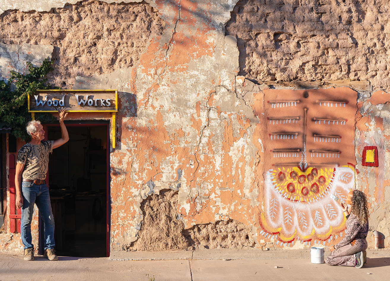 Paula Wilson and Mike Lagg work together on a mural