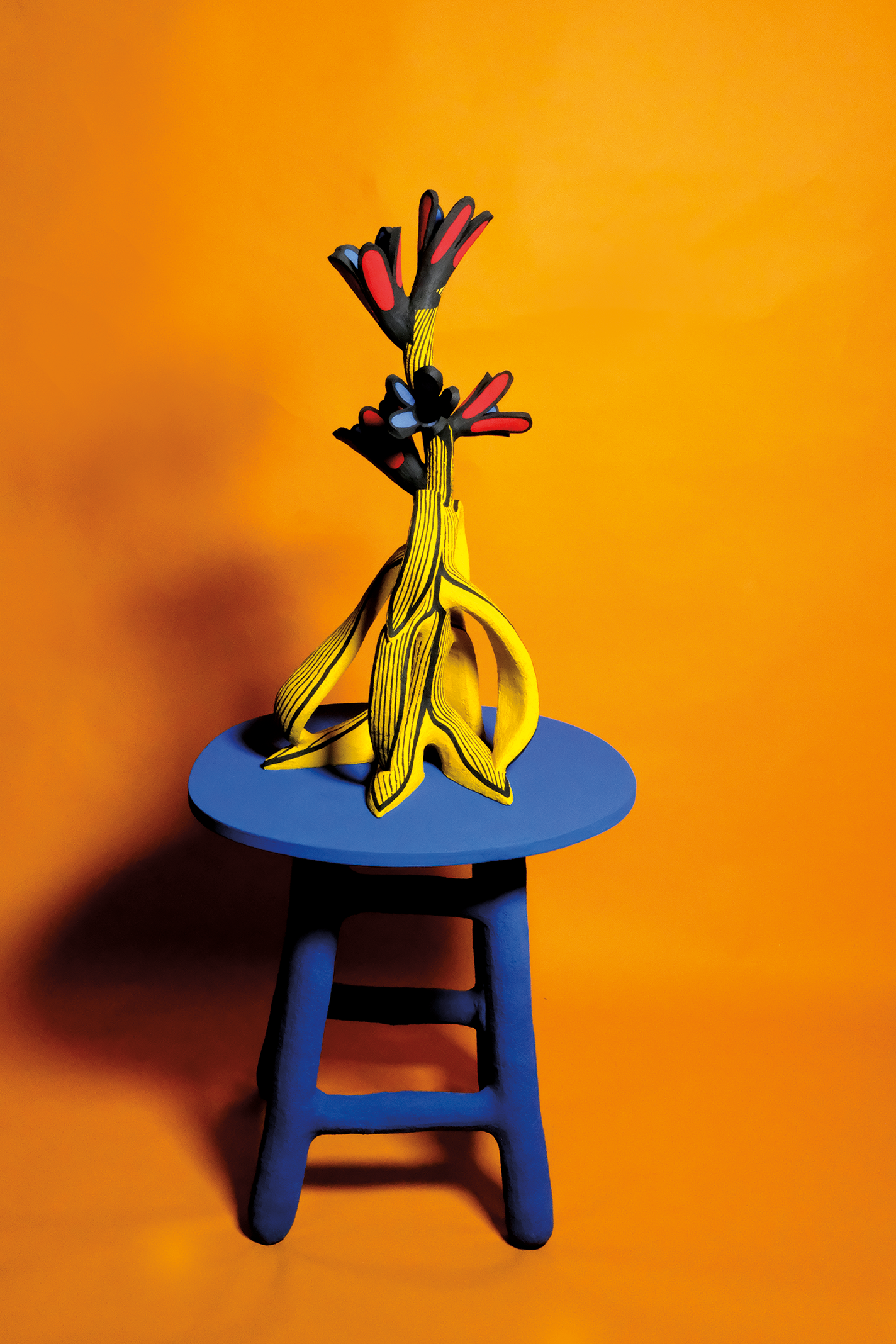 Vibrant stoneware sculpture with banana peels and flowers