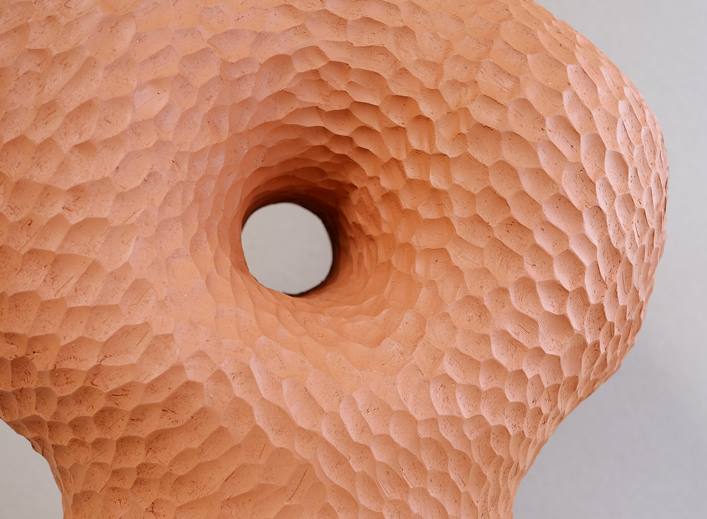 Donut-shaped terracotta planter with dimpled texture