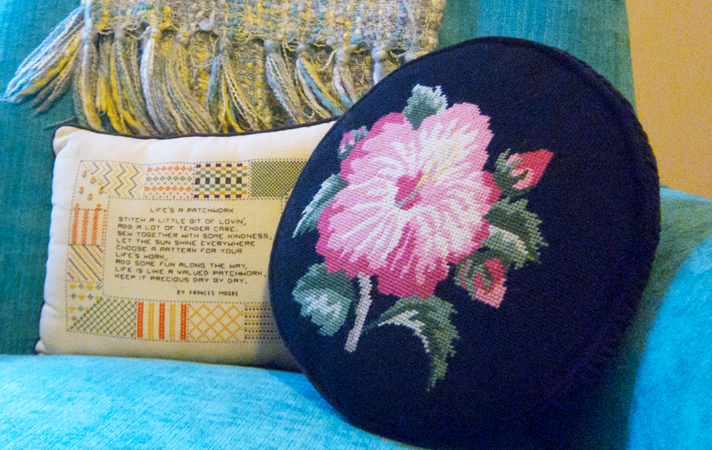 Family heirlooms including a needlepoint pillow.