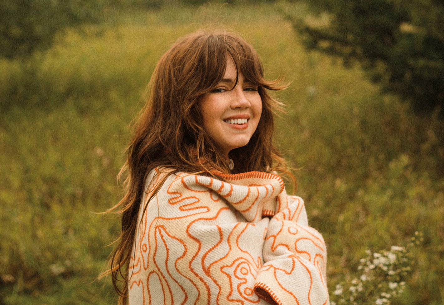 Artist Madison Holler wrapped in wool throw.