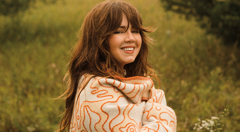 Artist Madison Holler wrapped in wool throw.