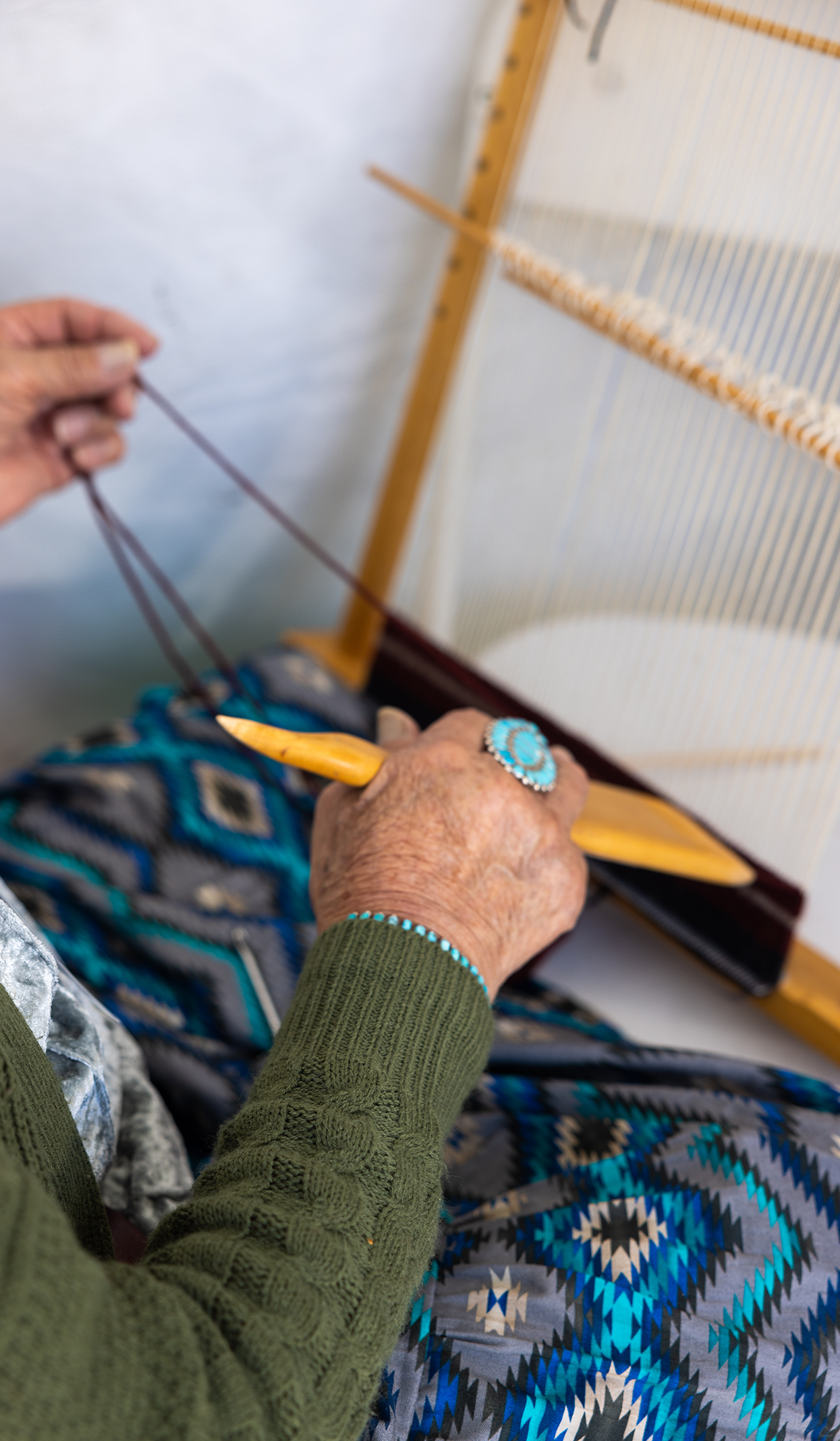 Person weaving on a loom