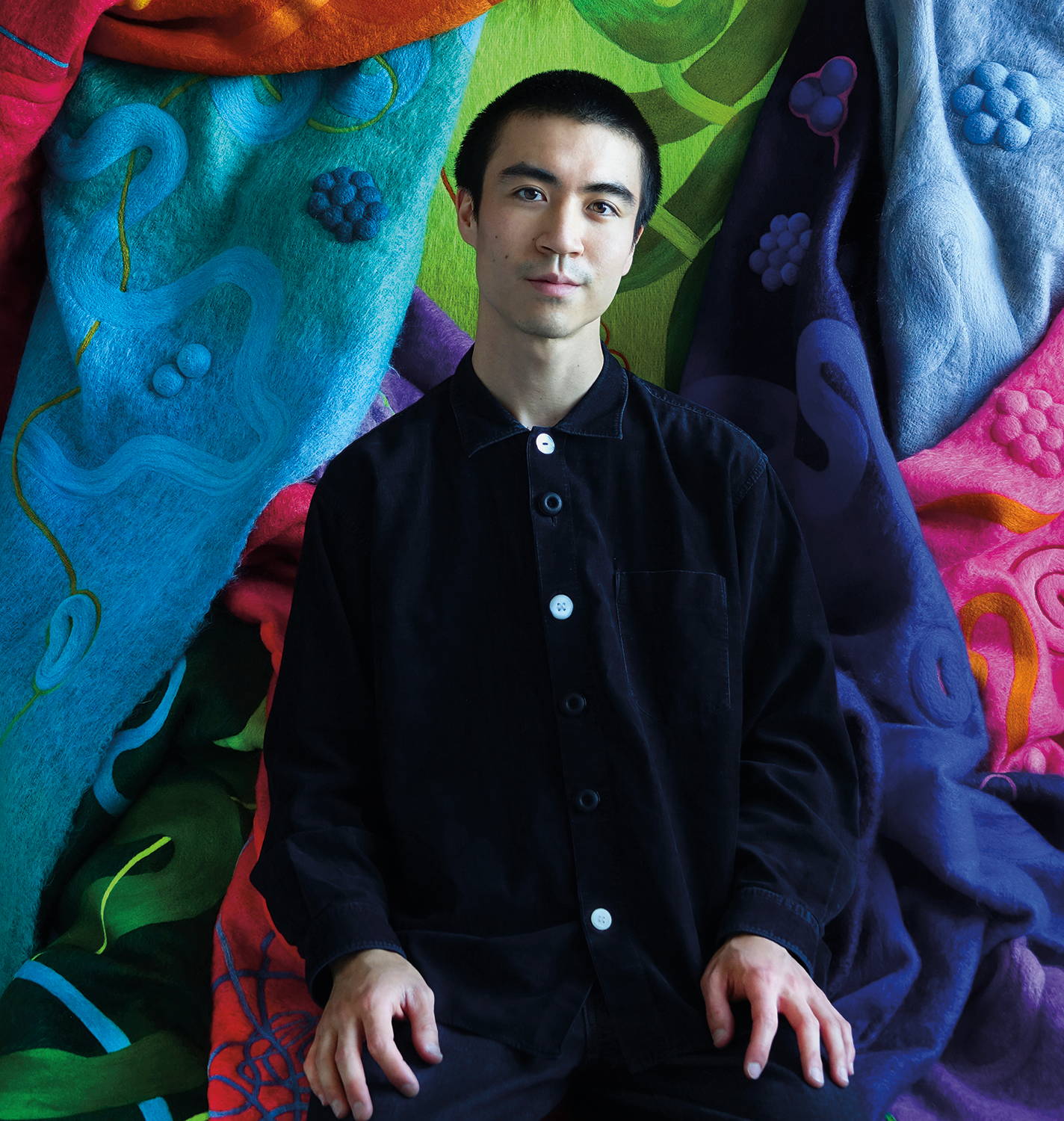 Artist Liam Lee with his felted tapestries.