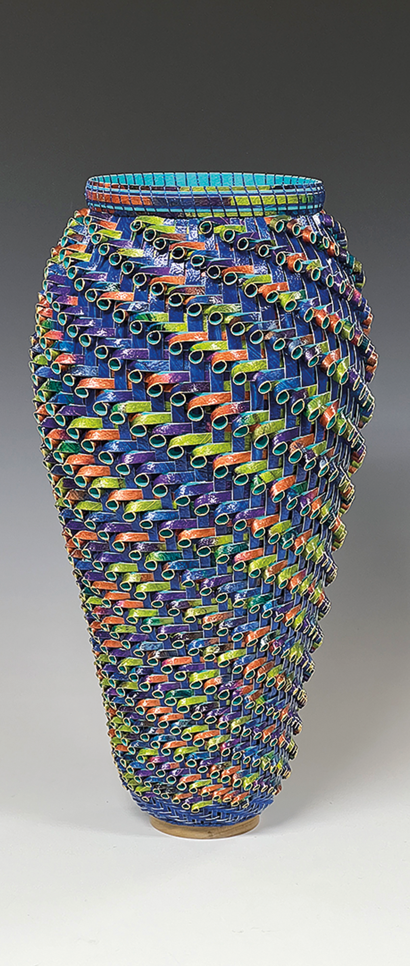 Basket made of paper in vibrant peacock colors