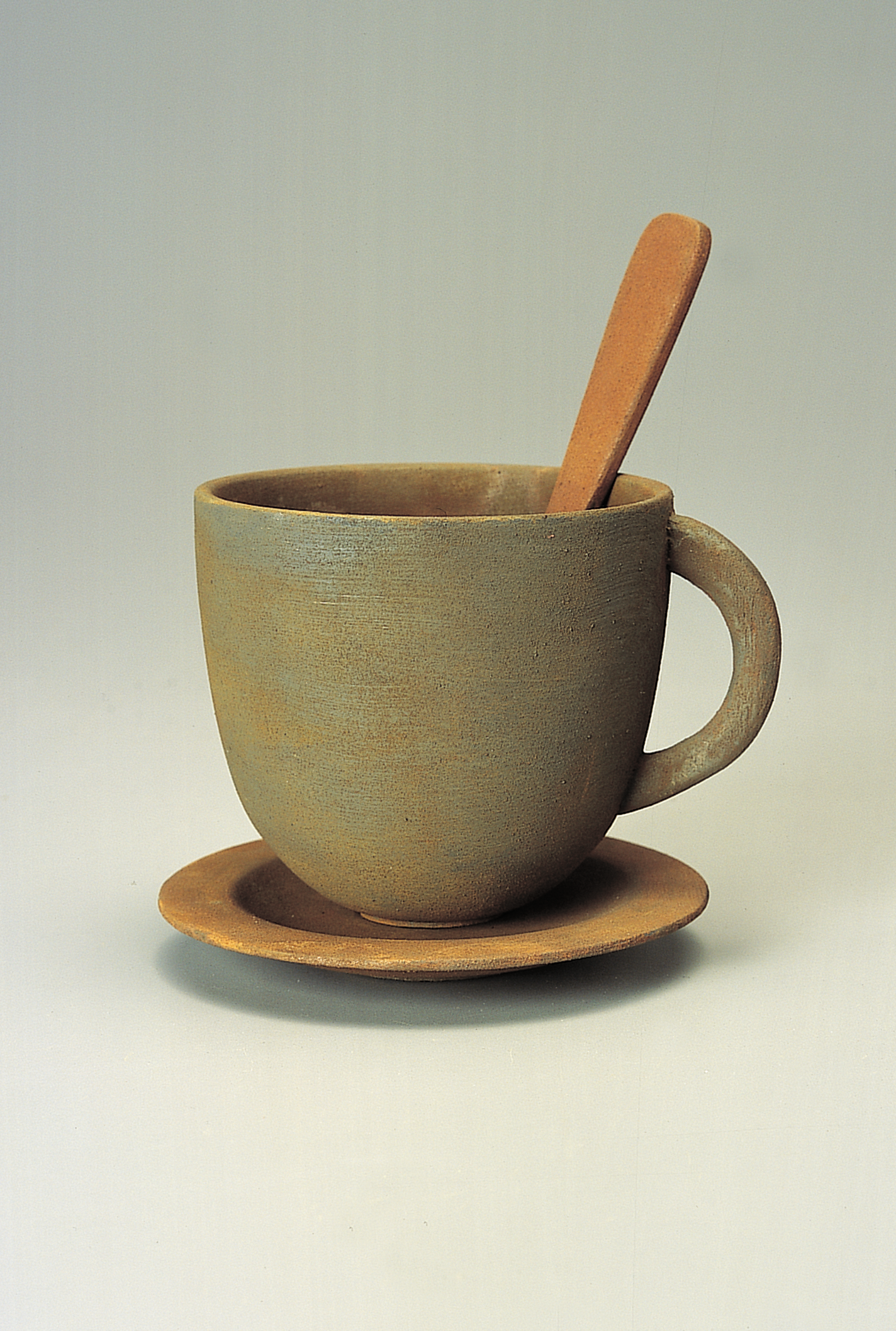Cup, saucer, and spoon carved from wood