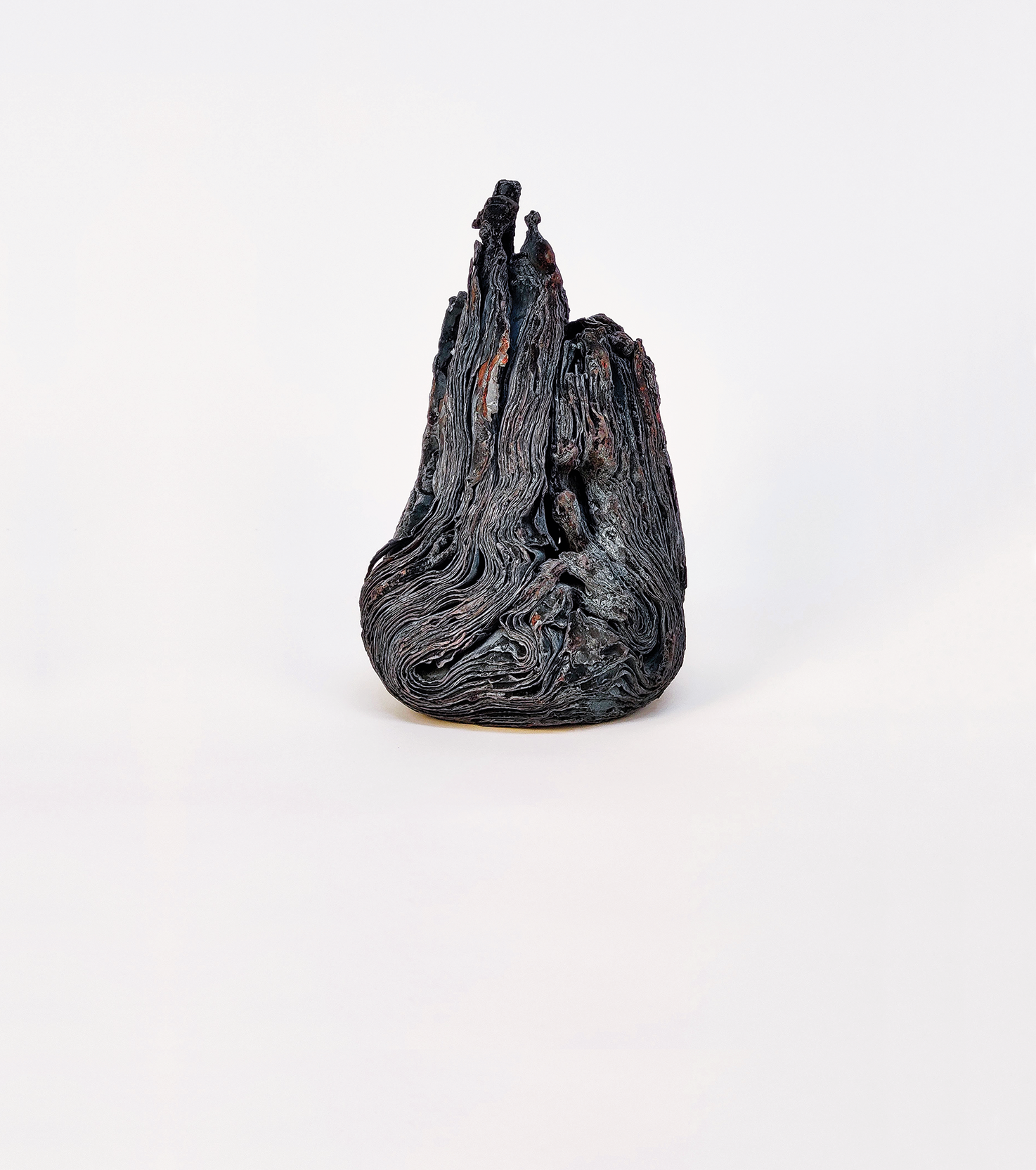 Intricately textured, folded iron sculpture