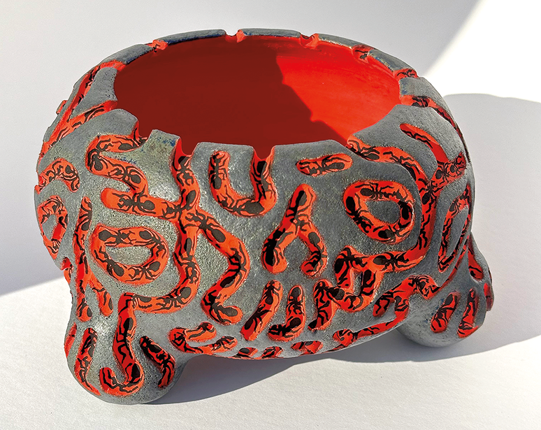 Stoneware bowl decorated with bright orange grooves and ants